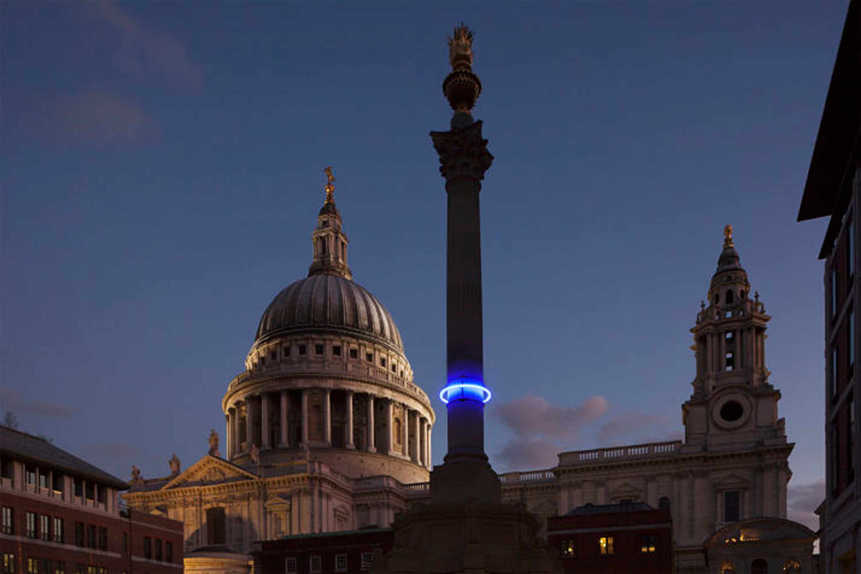 Plunge project by Arts Admin and artist Michael Pinsky. The monument in Paternoster Square has been fitted with a ring of blue light at 28m above sea levels to indicate where the sea levels will be in 1000 years time if we, the human race, continue our CO2 emmissions at current rate. An estimated hight of raised seal levels will be 28m, based on current available science. 3 monuments in London have been fitted with a ring of light at 28 m above sea levels, one is on the Duke of York Monument, another the monument in Paternoster Square and the third on the monument in Sevel Dials in Covent Garden.
